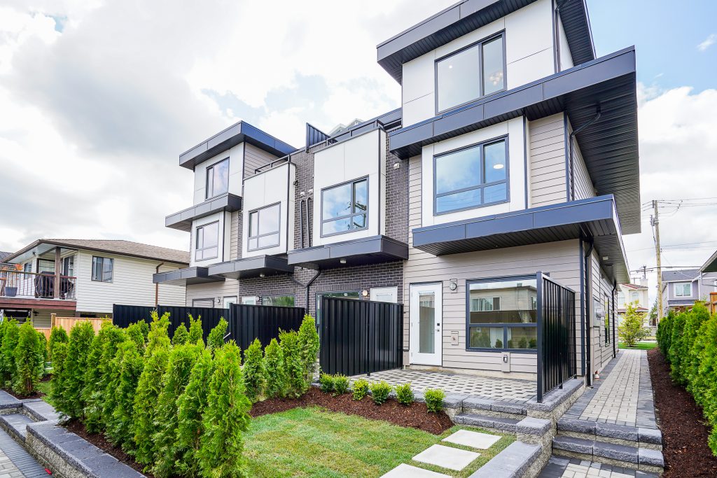 Coquitlam Multiplex front yard with a small grass area and simple, clean landscaping.