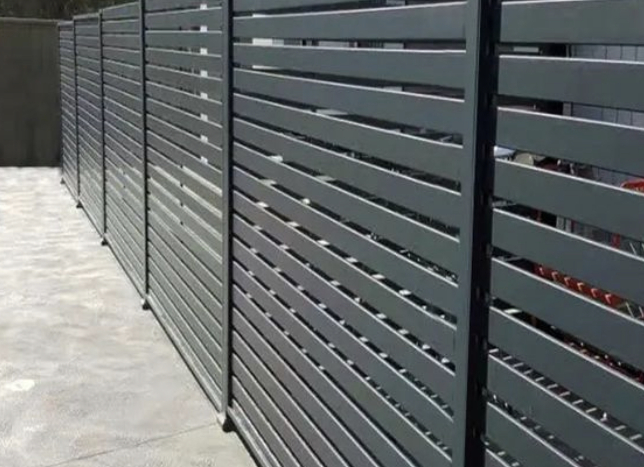Black aluminum fence in North Vancouver featuring horizontal slit design details.
