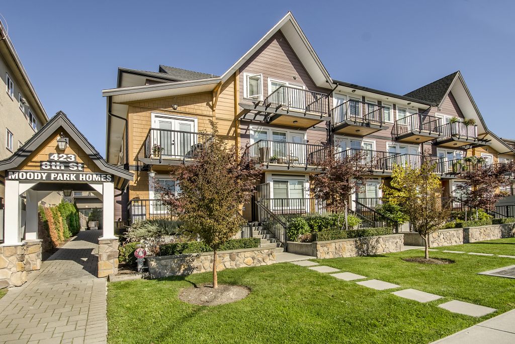 Multifamily townhomes featuring multi-level custom planter boxes filled with a variety of native plants.