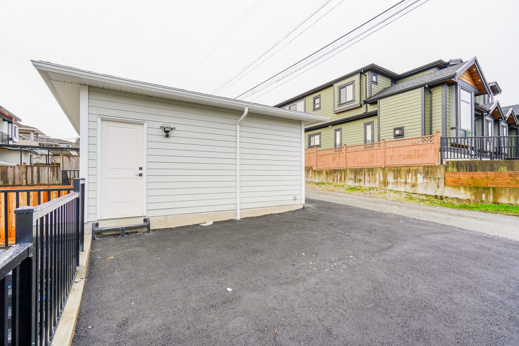 Burnaby backyard with a custom asphalt parking pad.