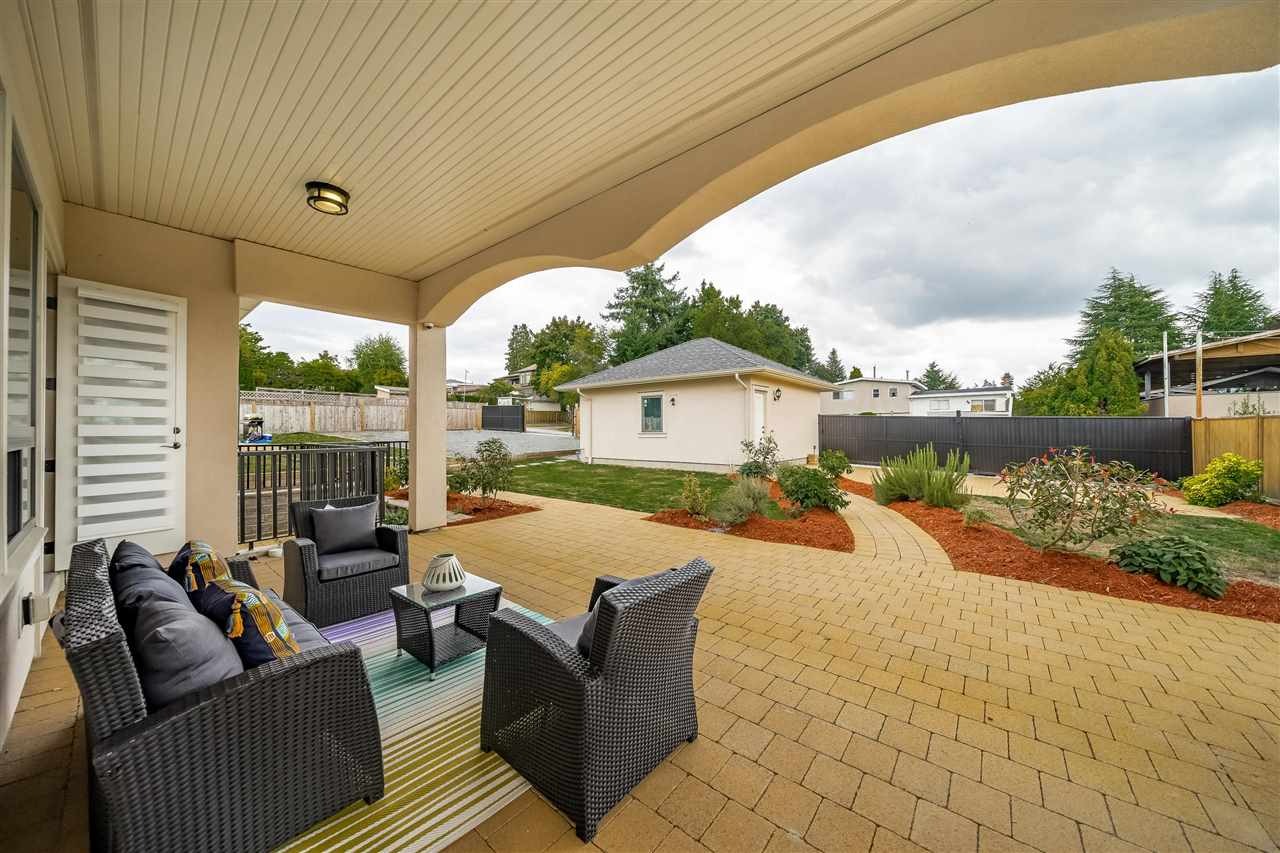 Oriental-style hosting area in Vancouver under a covered deck, designed for a fire pit or custom outdoor kitchen setup.
